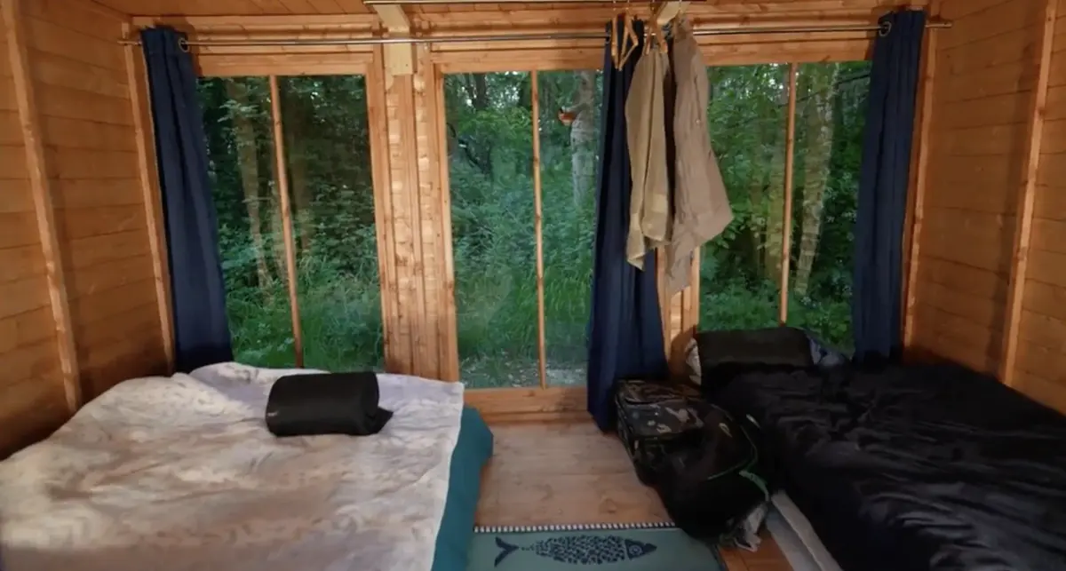 Inside a summerhouse cabin, made up with two beds